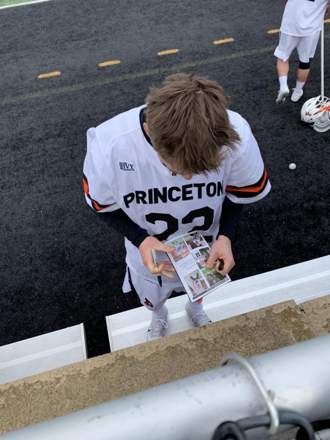 Former Princeton and current Duke attackman Michael Sowers signing autographs for fans after a game in 2020.