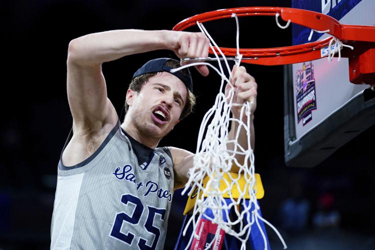 Edert cutting down the nets after winning the MAAC Championship that sent St. Peters to the March Madness tournament.