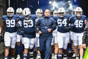 Coach James Franklin leading his Penn State team out of the tunnel before a 2021 game.