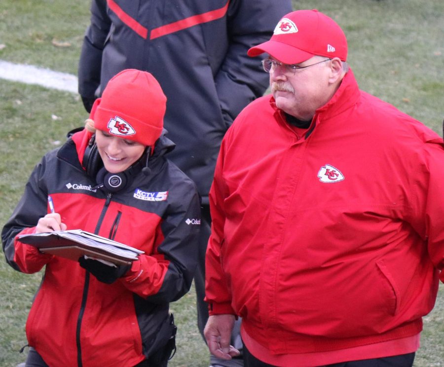 Andy Reid (right) talks to a reporter.