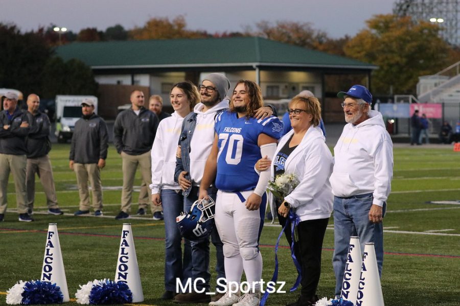 Falcons+celebrating+Moyer+on+his+Senior+night.