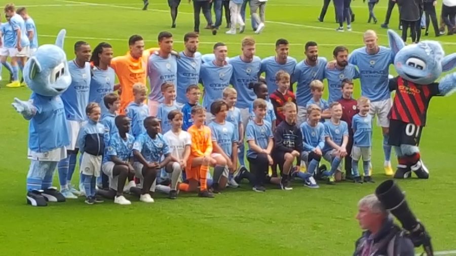 Manchester City team coming together for a team picture.
