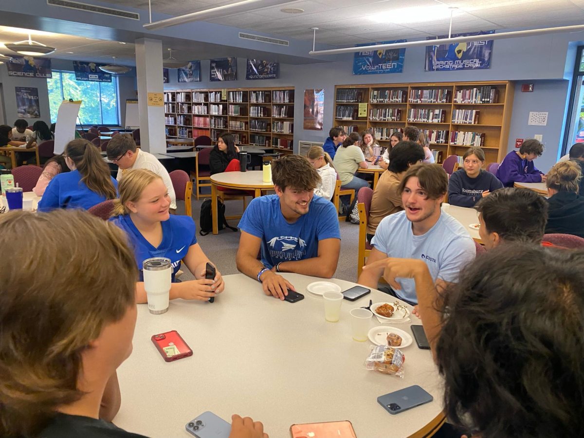 LDHS Students sharing a laugh in the library before the start of SPIRIT Day. 