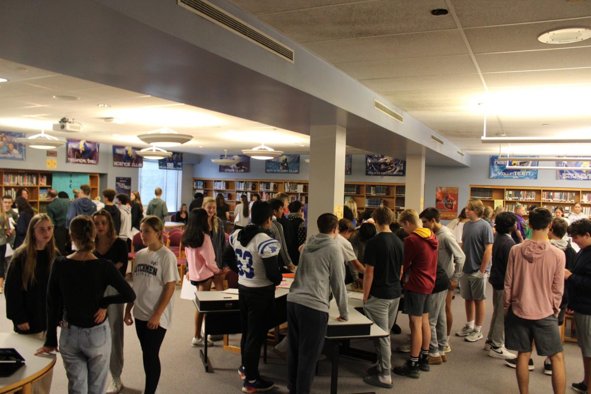Students at Club Day speak to club representatives and interact with club displays.