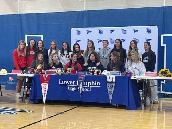 Lower Dauphin signed athletes pose for a picture in the LDHS gymnasium. 17 athletes, representing five different LD sports teams, signed their national letters of intent (NLI) on Wednesday, Nov. 8 to continue their playing careers.