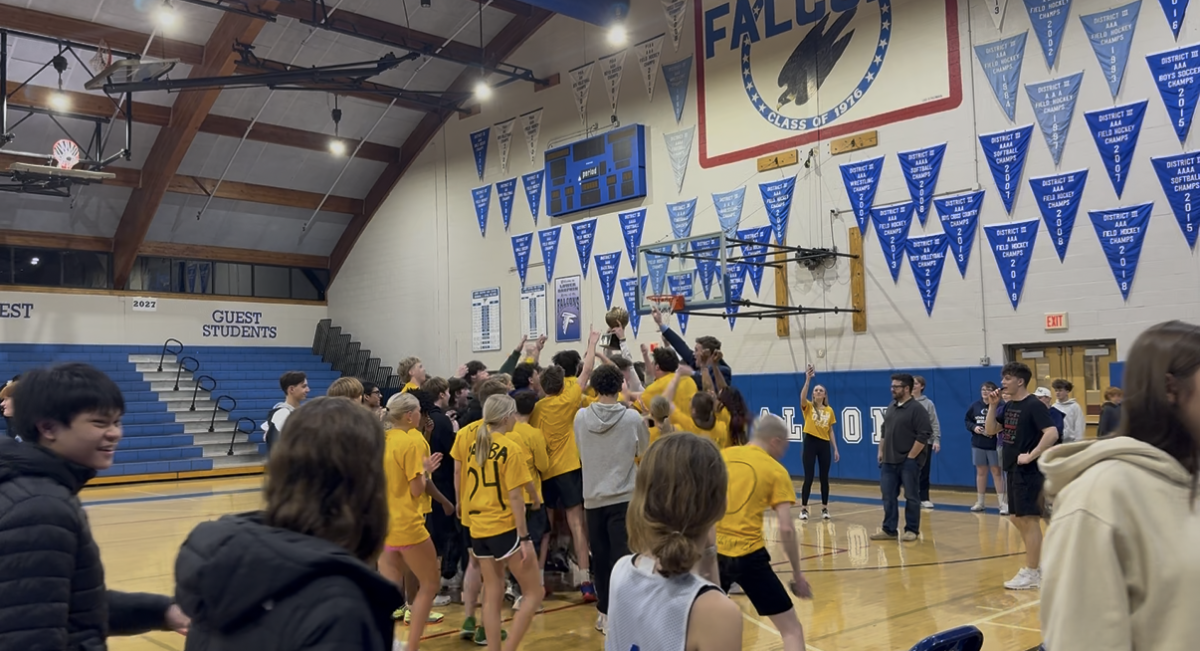 Student team celebrating their students vs. teachers basketball game win.